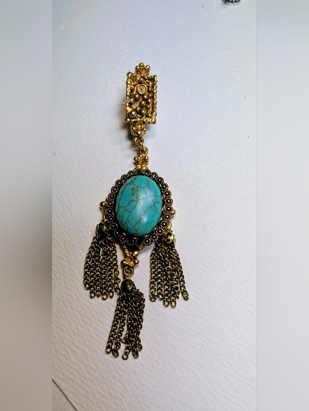 granuated gold ,tassels,turquoise oval.